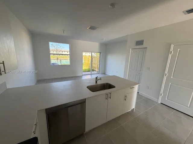 a kitchen with a sink and a stove top oven