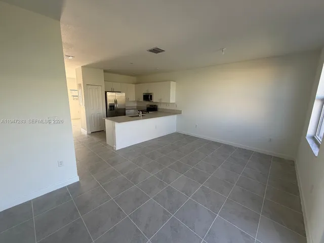a large kitchen with cabinets and a stove top oven