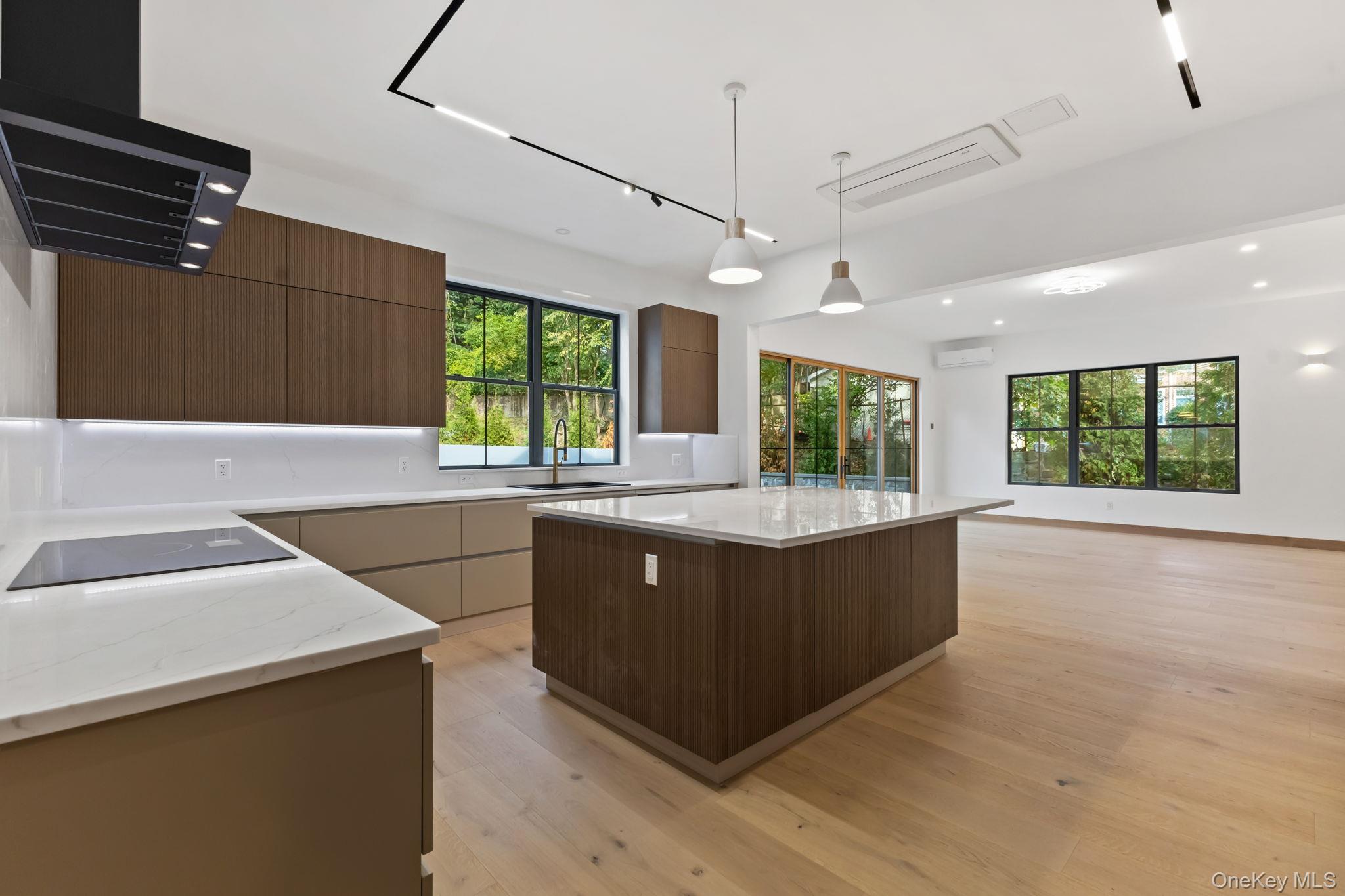 22 Whippoorwill Road East Armonk, NY 10504 - Photo 14 of 47 a large kitchen with kitchen island a large counter top space appliances and windows