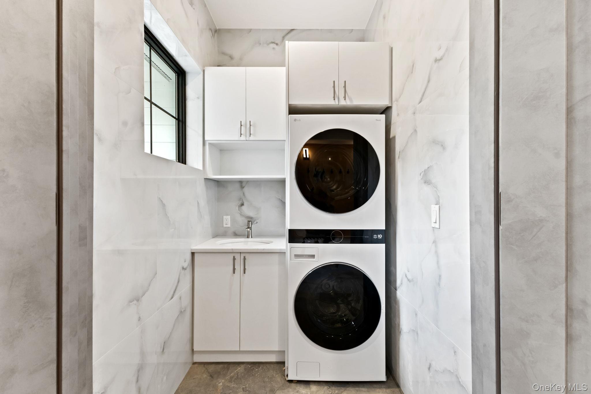 22 Whippoorwill Road East Armonk, NY 10504 - Photo 16 of 47 a view of a hallway with washer and dryer