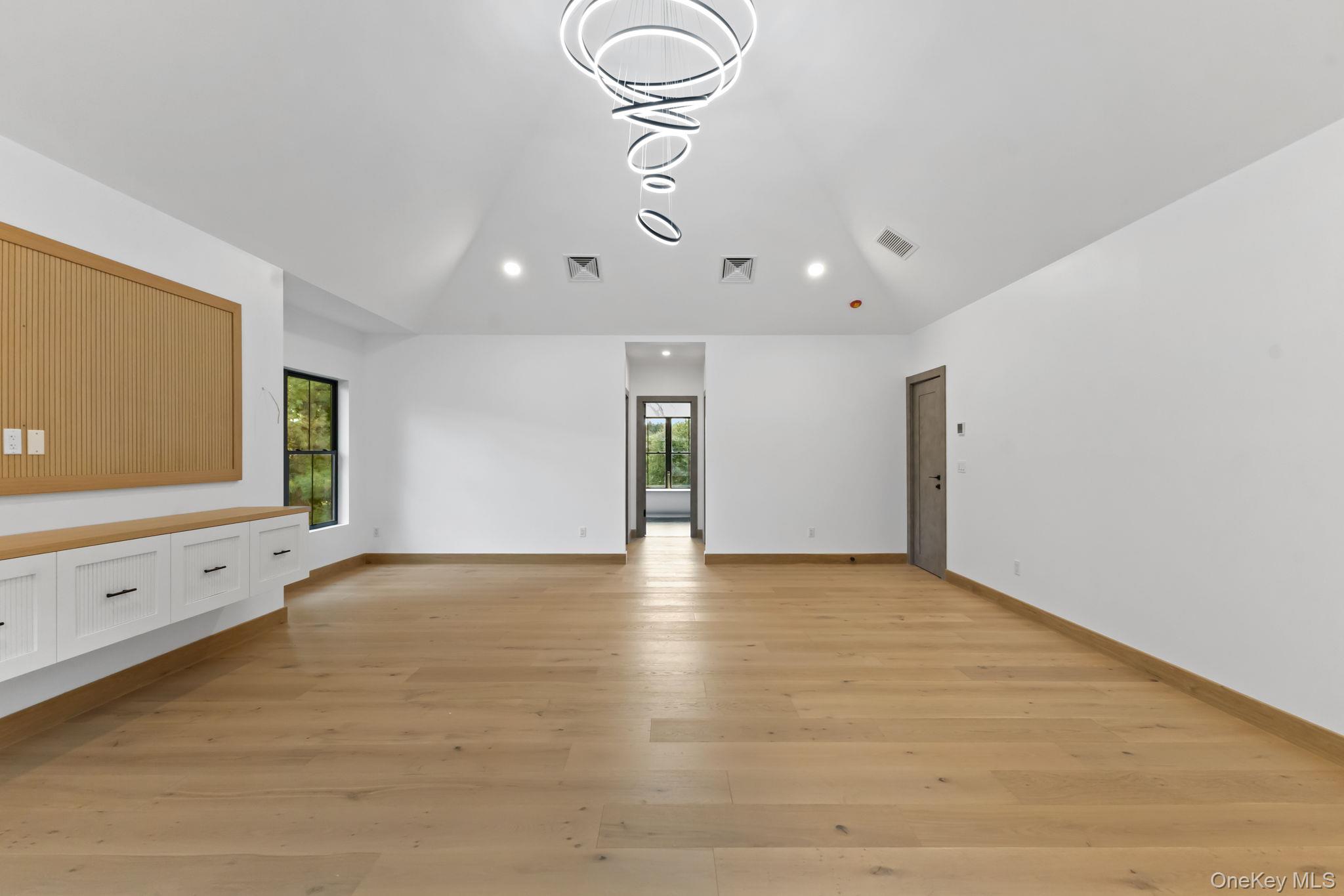 22 Whippoorwill Road East Armonk, NY 10504 - Photo 19 of 47 a view of an empty room with window and wooden floor