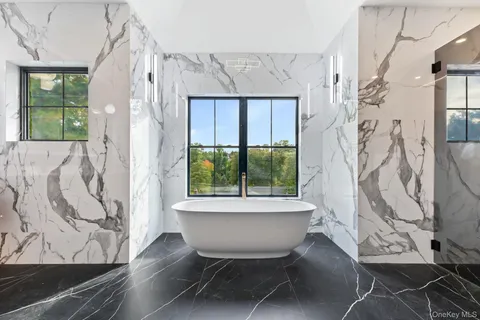 a bathroom with a bathtub and shower