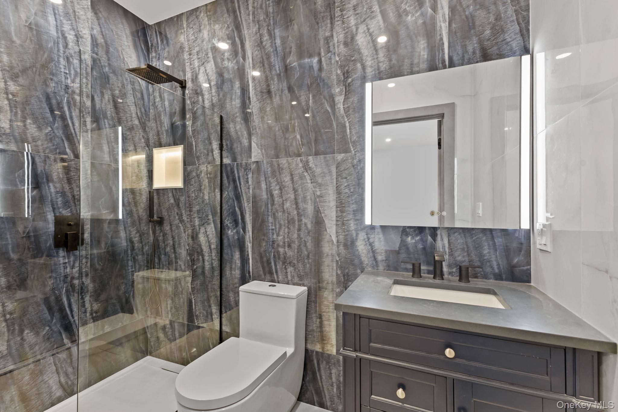 22 Whippoorwill Road East Armonk, NY 10504 - Photo 25 of 47 a bathroom with a toilet a sink shower and mirror