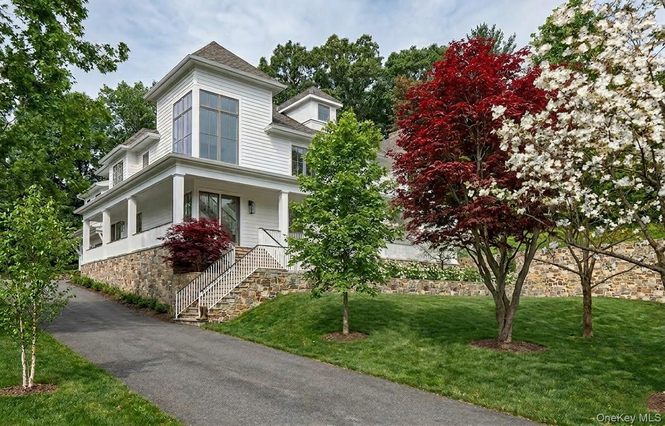 22 Whippoorwill Road East Armonk, NY 10504 - Photo 45 of 50 a front view of a house with a yard and trees