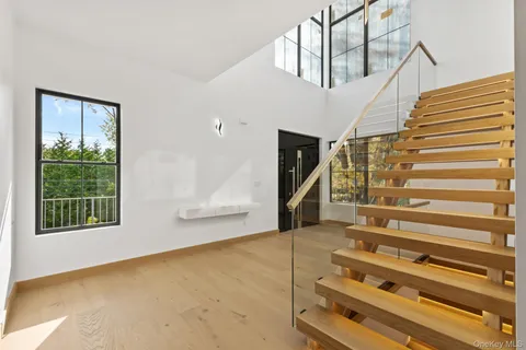 a view of entryway and hall with wooden floor
