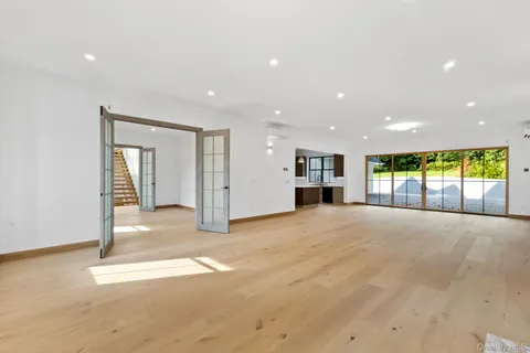 a view of an empty room with a fireplace and a window