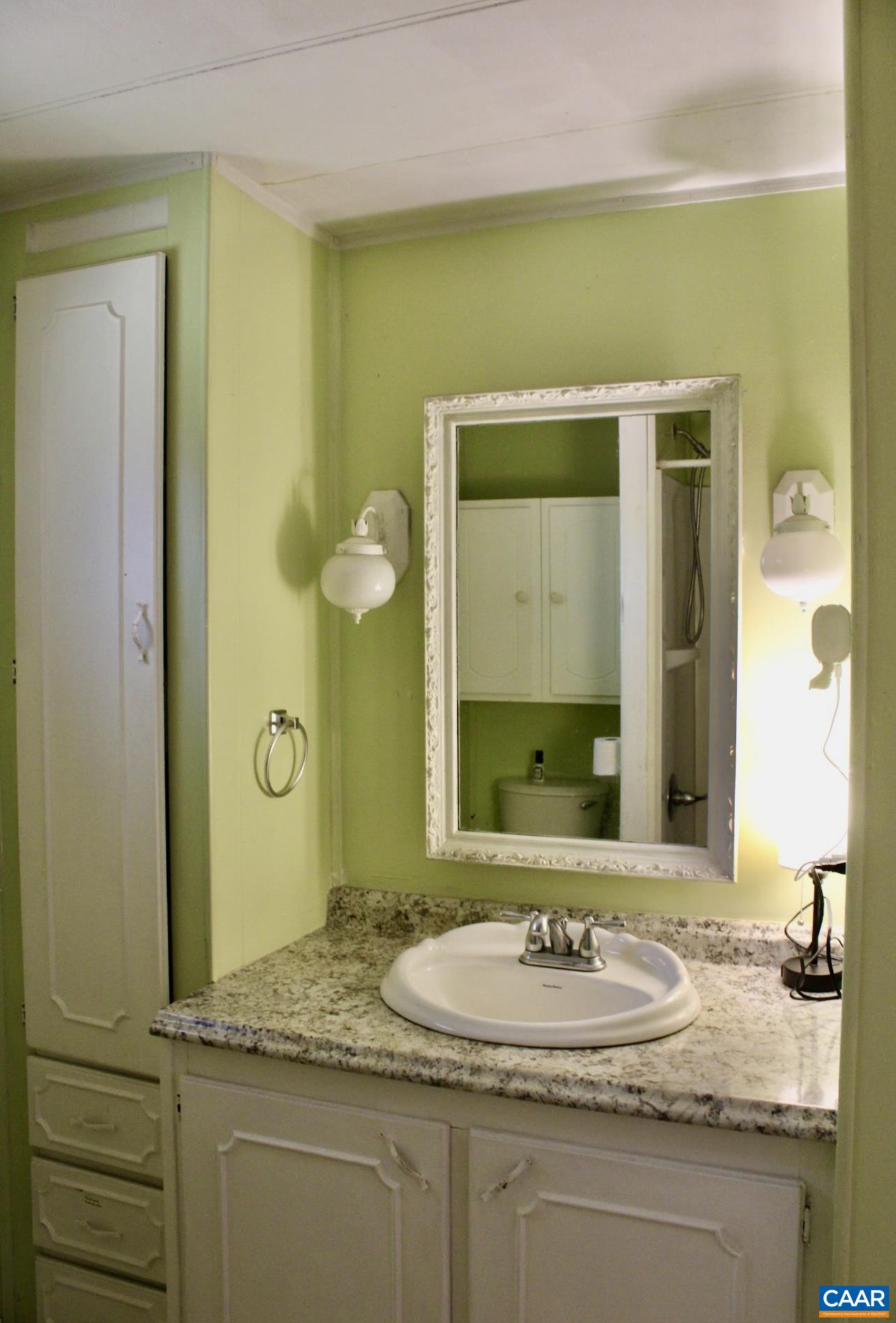6790 Foster Ridge Charlottesville, VA 22903 - Photo 14 of 43 a bathroom with a granite countertop sink and a mirror
