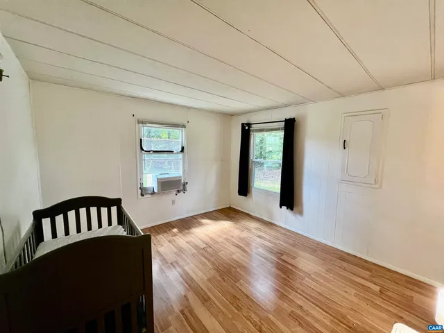 a view of a livingroom with wooden floor and staircase
