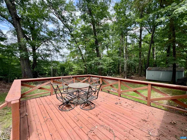 a view of deck with chairs and wooden floor