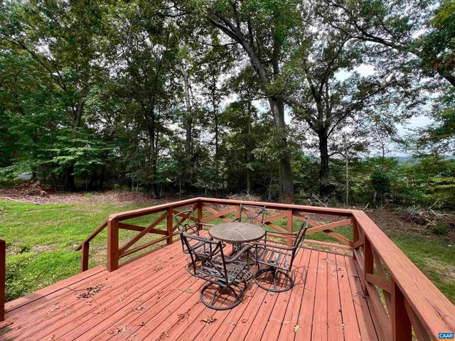 a view of a roof deck with couches and wooden floor