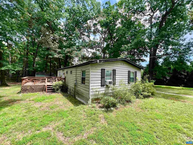 a backyard of a house with yard and trampoline