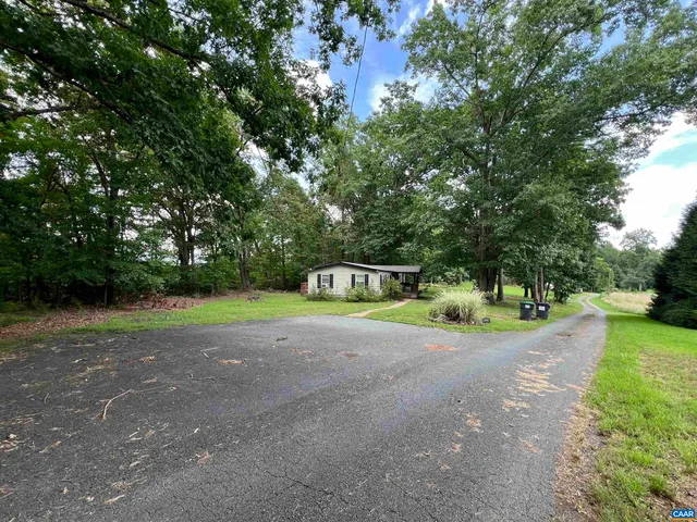 a pathway of a house with a yard