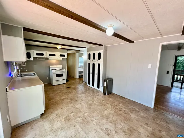 a view of livingroom with furniture and refrigerator