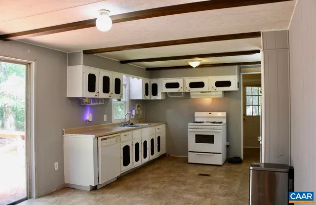 a kitchen with stainless steel appliances granite countertop a stove and a microwave