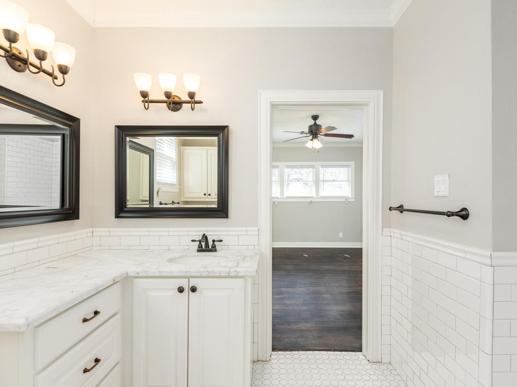 4528 Avenue R 1/2 Galveston, TX 77551 - Photo 21 of 22 a bathroom with a sink a vanity and a mirror