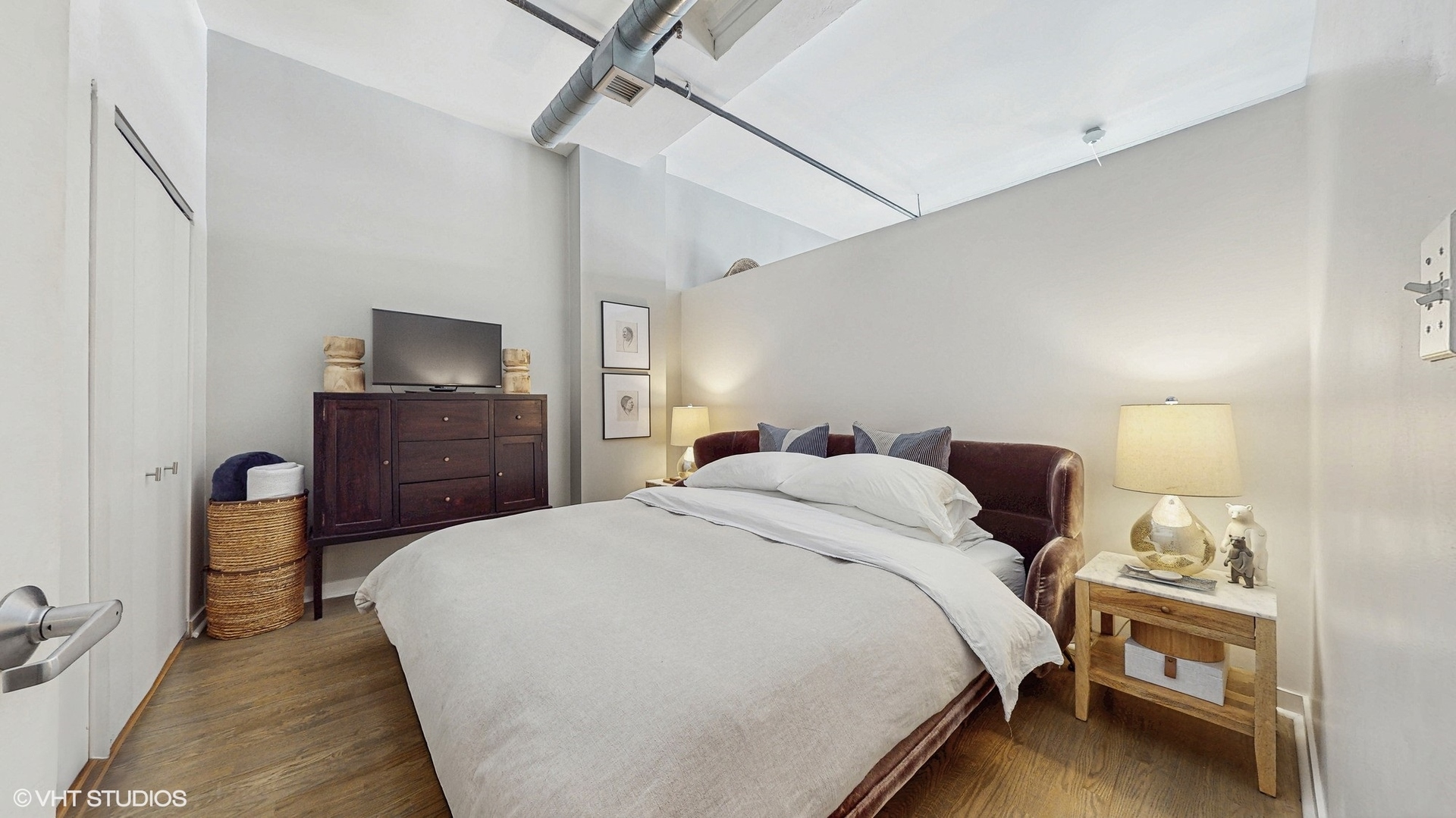 4715 North Racine Avenue, Unit 305 Chicago, IL 60640 - Photo 11 of 24 a bedroom with a bed and a flat tv screen on wall