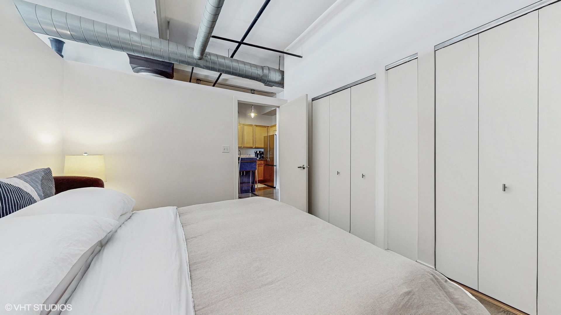 4715 North Racine Avenue, Unit 305 Chicago, IL 60640 - Photo 13 of 24 a bedroom with a bed and a walk in closet