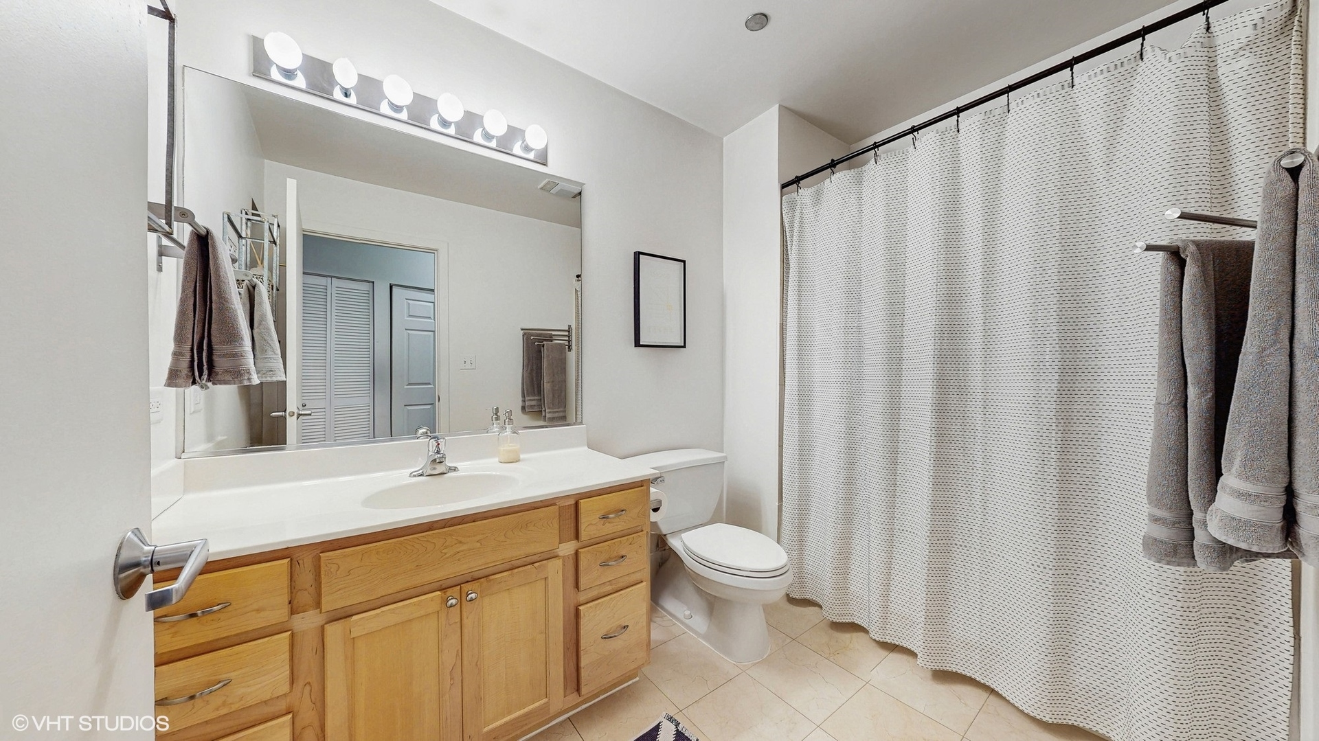 4715 North Racine Avenue, Unit 305 Chicago, IL 60640 - Photo 14 of 24 a bathroom with a sink a toilet and shower