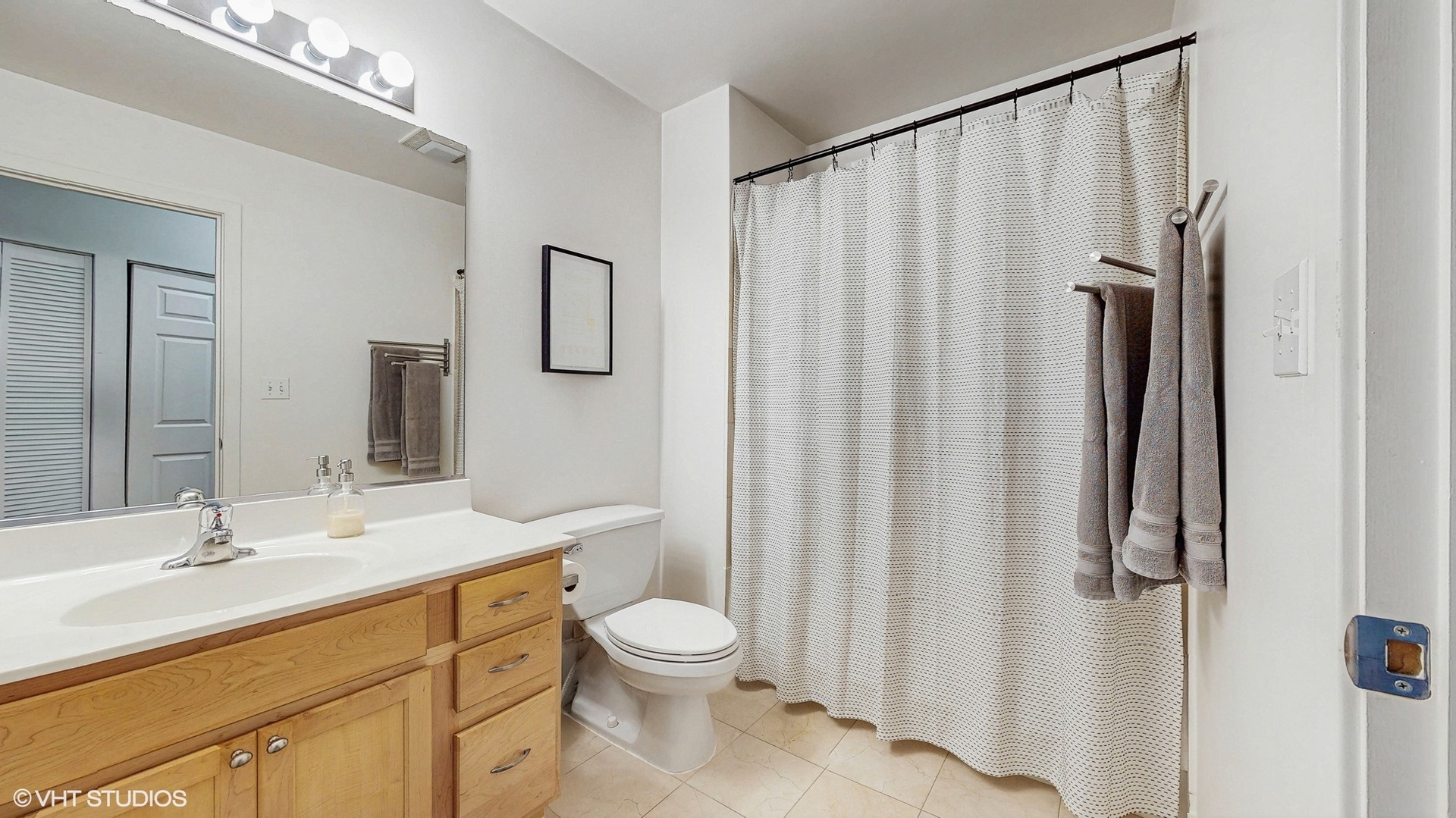 4715 North Racine Avenue, Unit 305 Chicago, IL 60640 - Photo 16 of 24 a bathroom with a granite countertop sink toilet and shower