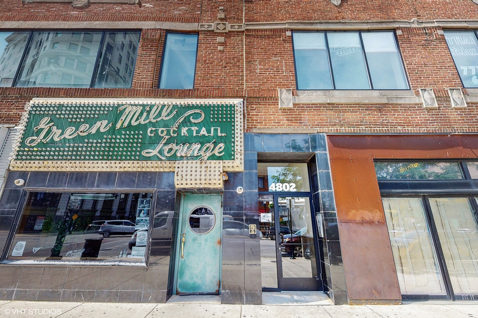 4715 North Racine Avenue, Unit 305 Chicago, IL 60640 - Photo 19 of 24 a front view of a building with retail shops