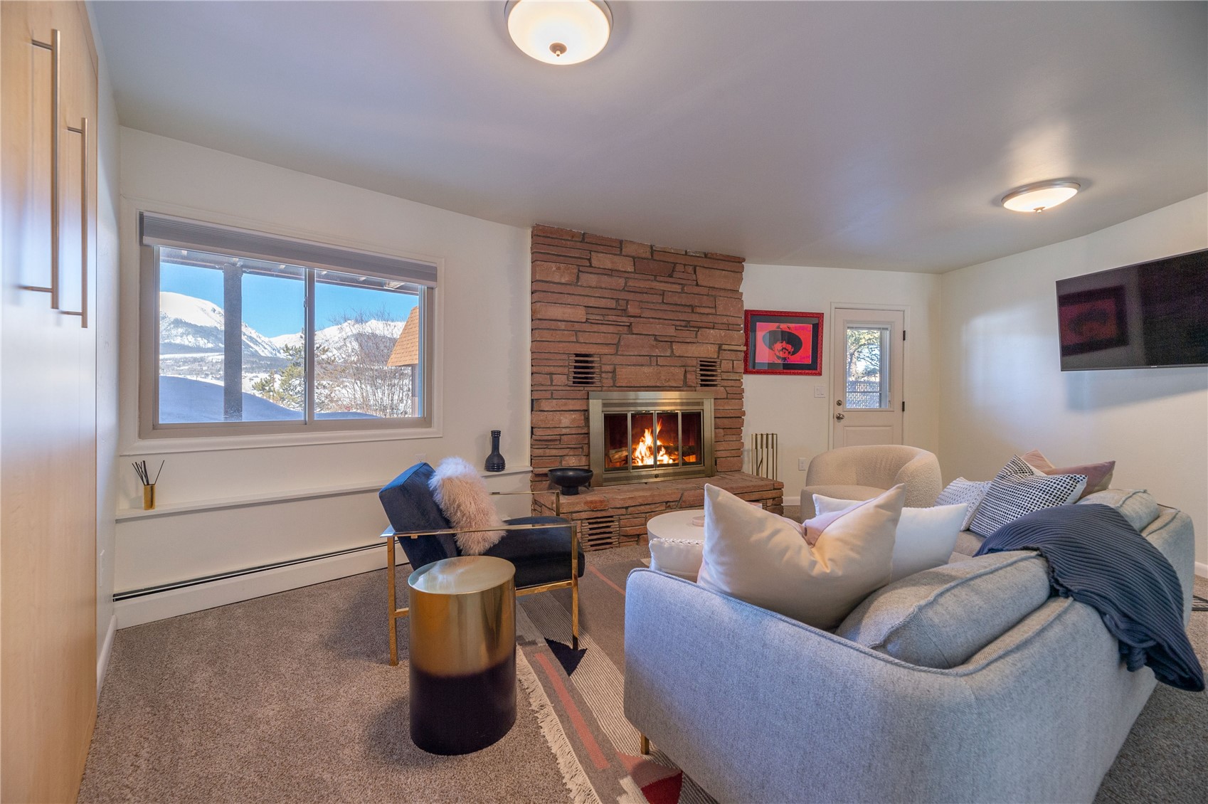 340 Buffalo Street Dillon, CO 80435 - Photo 24 of 40 a living room with furniture a flat screen tv and a fireplace