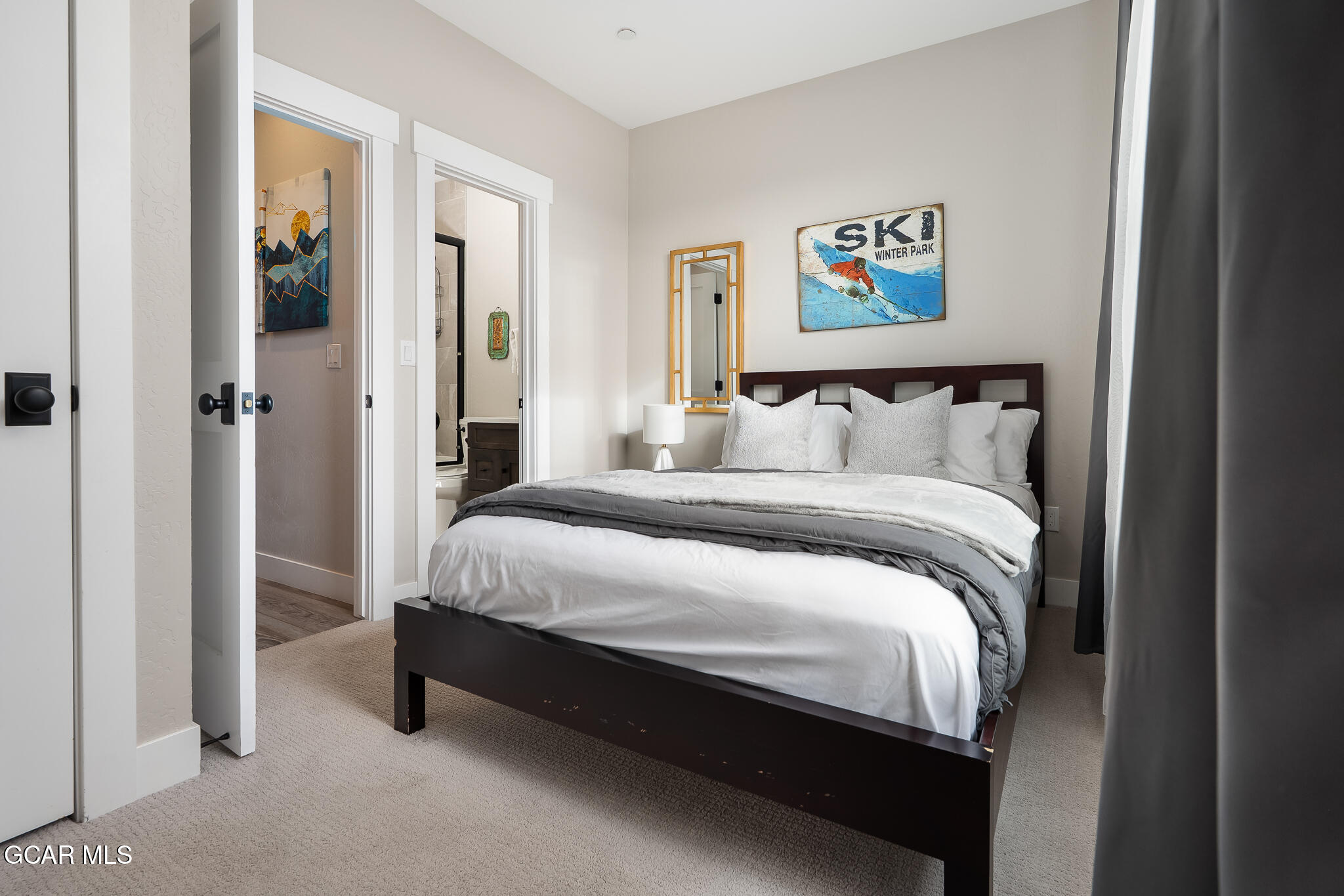 74 Eagle Ridge Drive Granby, CO 80446 - Photo 23 of 44 a bed sitting in a bedroom next to a bathroom
