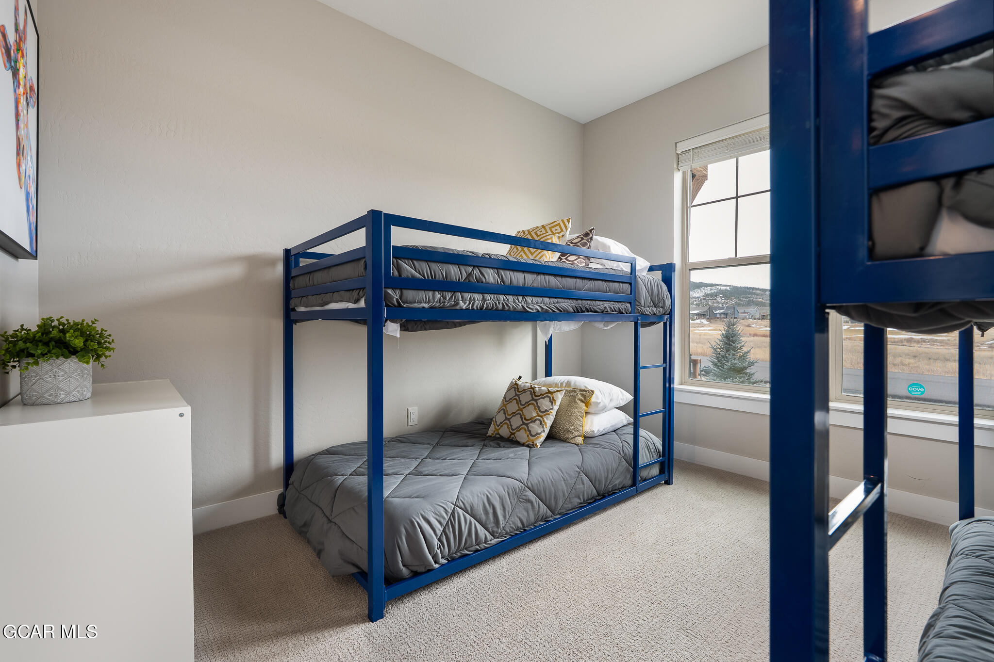 74 Eagle Ridge Drive Granby, CO 80446 - Photo 27 of 44 a bedroom with a bed and a potted plant