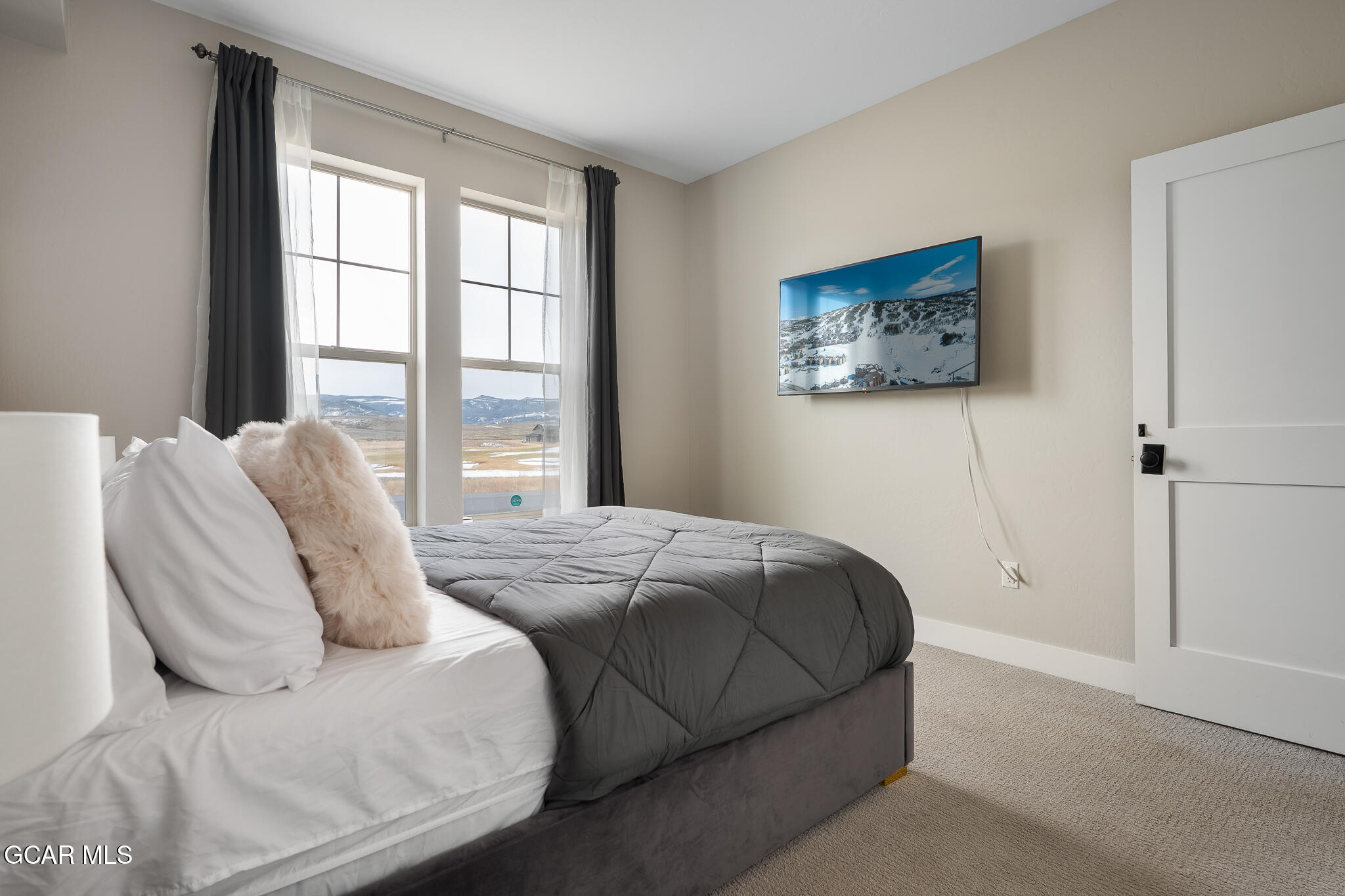 74 Eagle Ridge Drive Granby, CO 80446 - Photo 30 of 44 a bedroom with a bed and a large window