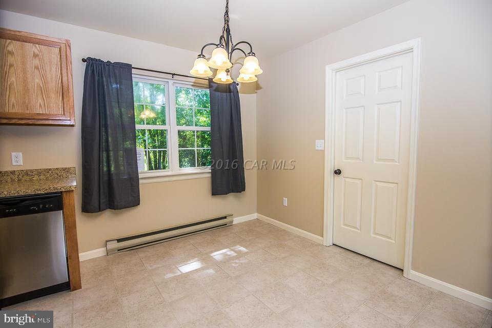 29890 Deal Island Road Princess Anne, MD 21853 - Photo 10 of 32 a view of an empty room with window wooden floor and cabinet