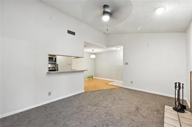 a view of a kitchen with a sink and a refrigerator