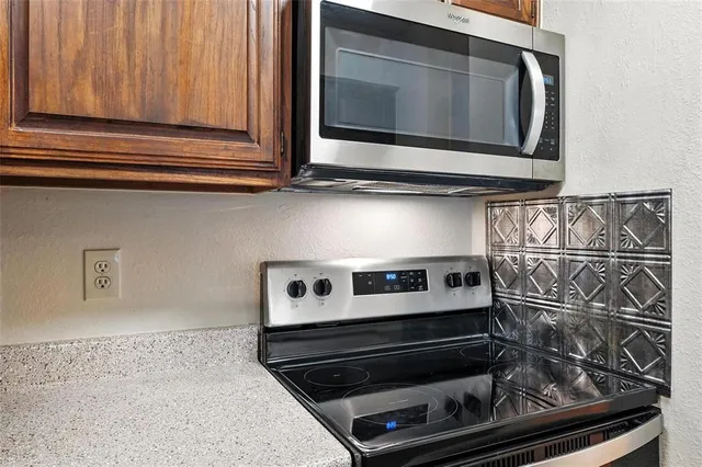 a kitchen with a stove and a microwave
