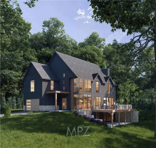 a front view of a house with a yard and green space