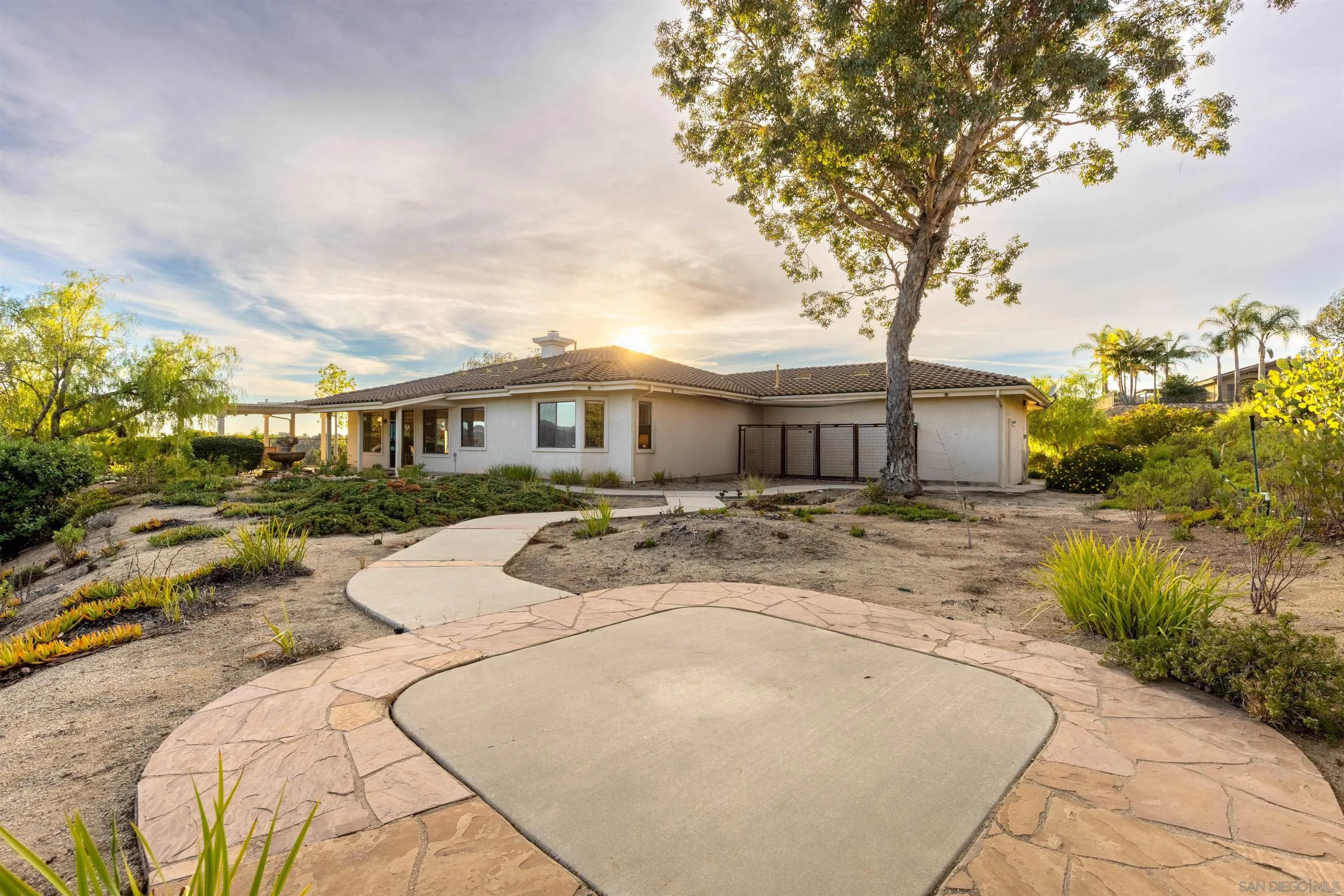3640 Genista Place Fallbrook, CA 92028 - Photo 30 of 48 a front view of a house with a yard and garage