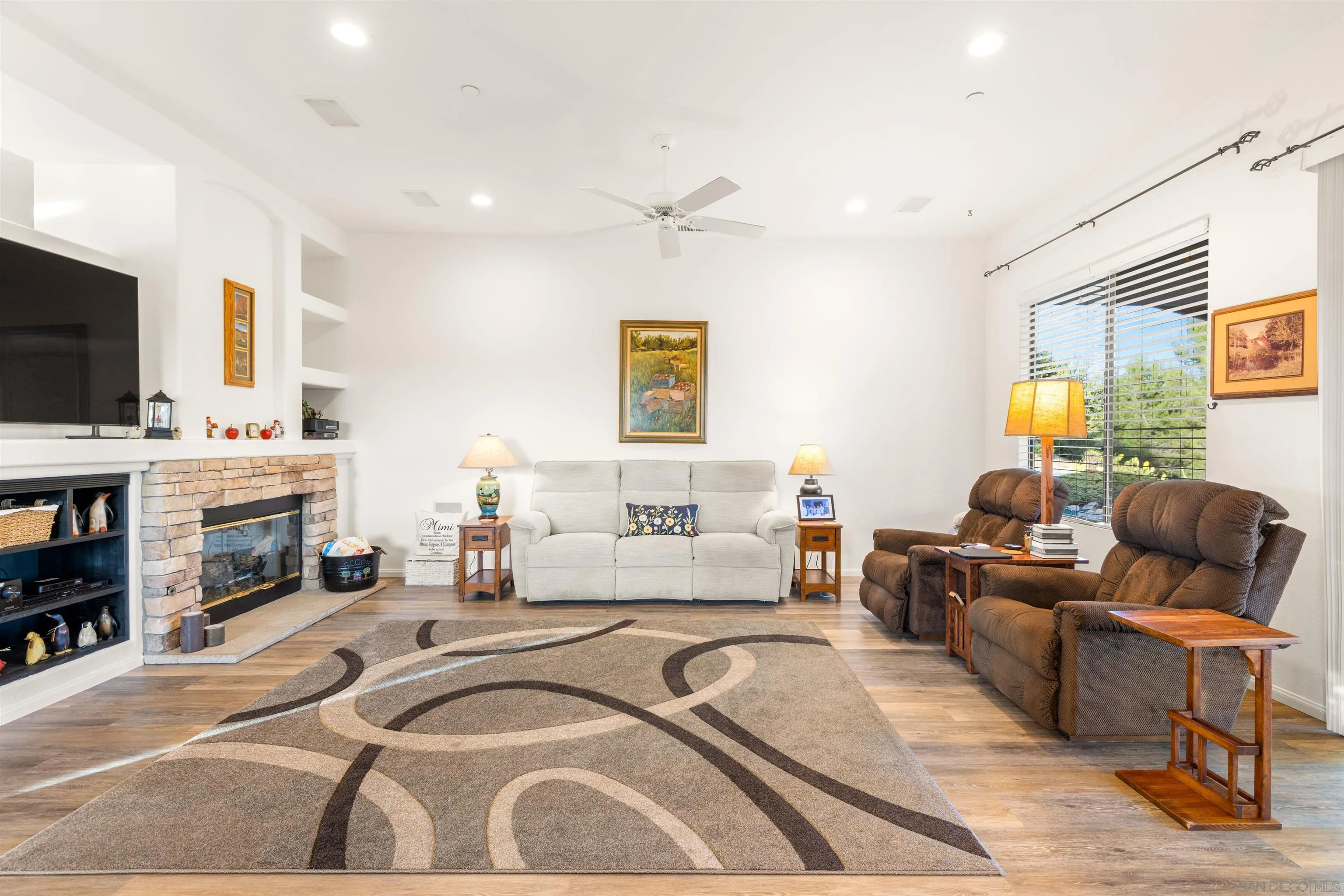 3640 Genista Place Fallbrook, CA 92028 - Photo 9 of 48 a living room with fireplace furniture and a flat screen tv
