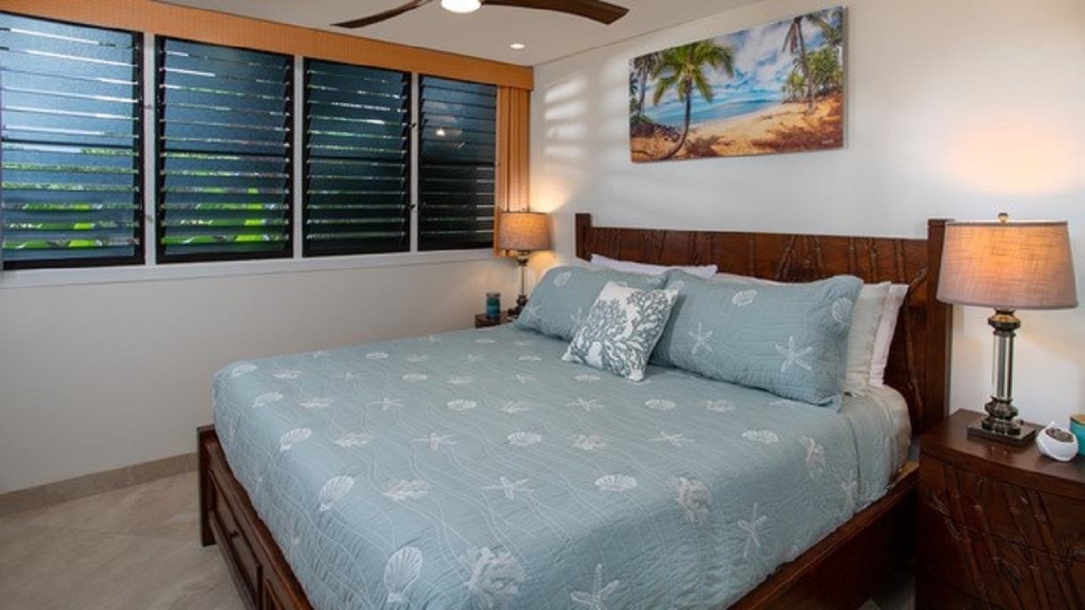 3701 Lower Honoapiilani Road, Unit 103 Lahaina, HI 96761 - Photo 15 of 29 a bed sitting in a bedroom next to a window