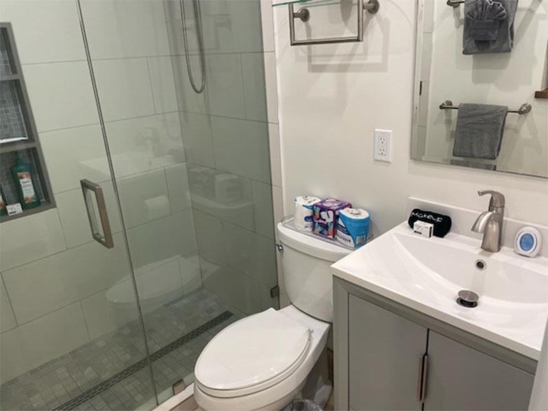 3701 Lower Honoapiilani Road, Unit 103 Lahaina, HI 96761 - Photo 18 of 29 a white toilet sitting next to a bathroom sink