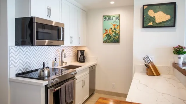 a kitchen with stainless steel appliances granite countertop a refrigerator and a stove top oven