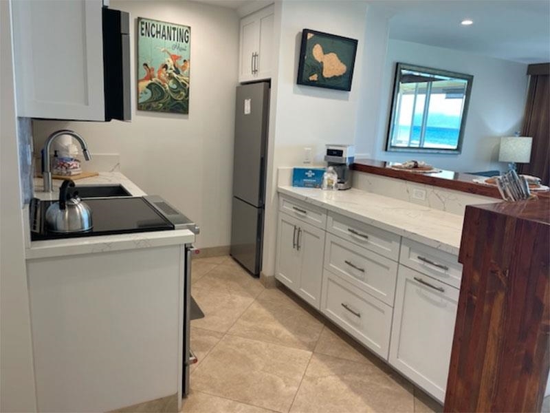 3701 Lower Honoapiilani Road, Unit 103 Lahaina, HI 96761 - Photo 4 of 29 a kitchen with cabinets appliances and a sink