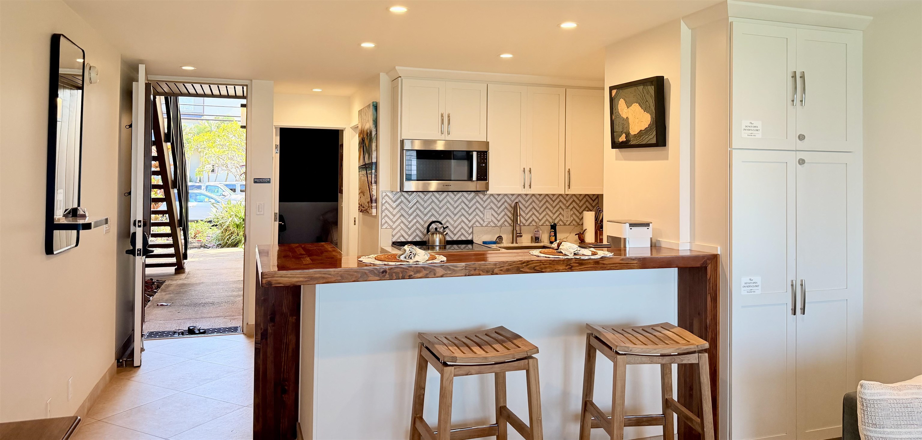 3701 Lower Honoapiilani Road, Unit 103 Lahaina, HI 96761 - Photo 5 of 38 a kitchen with stainless steel appliances granite countertop a refrigerator and a stove top oven