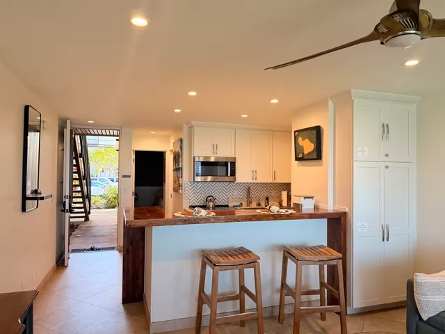 a living room with furniture a rug and a table
