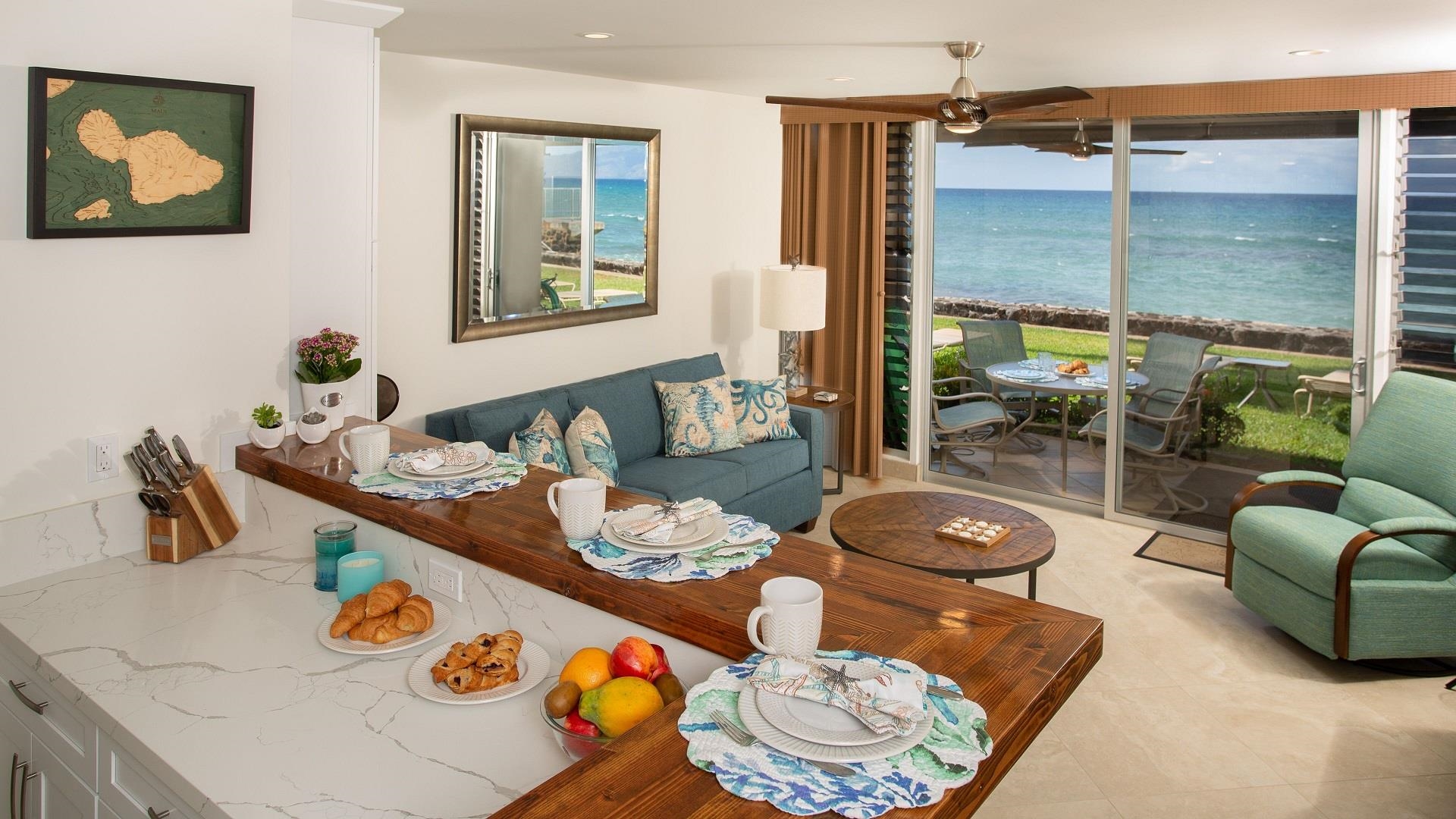 3701 Lower Honoapiilani Road, Unit 103 Lahaina, HI 96761 - Photo 7 of 29 a living room with furniture and a table