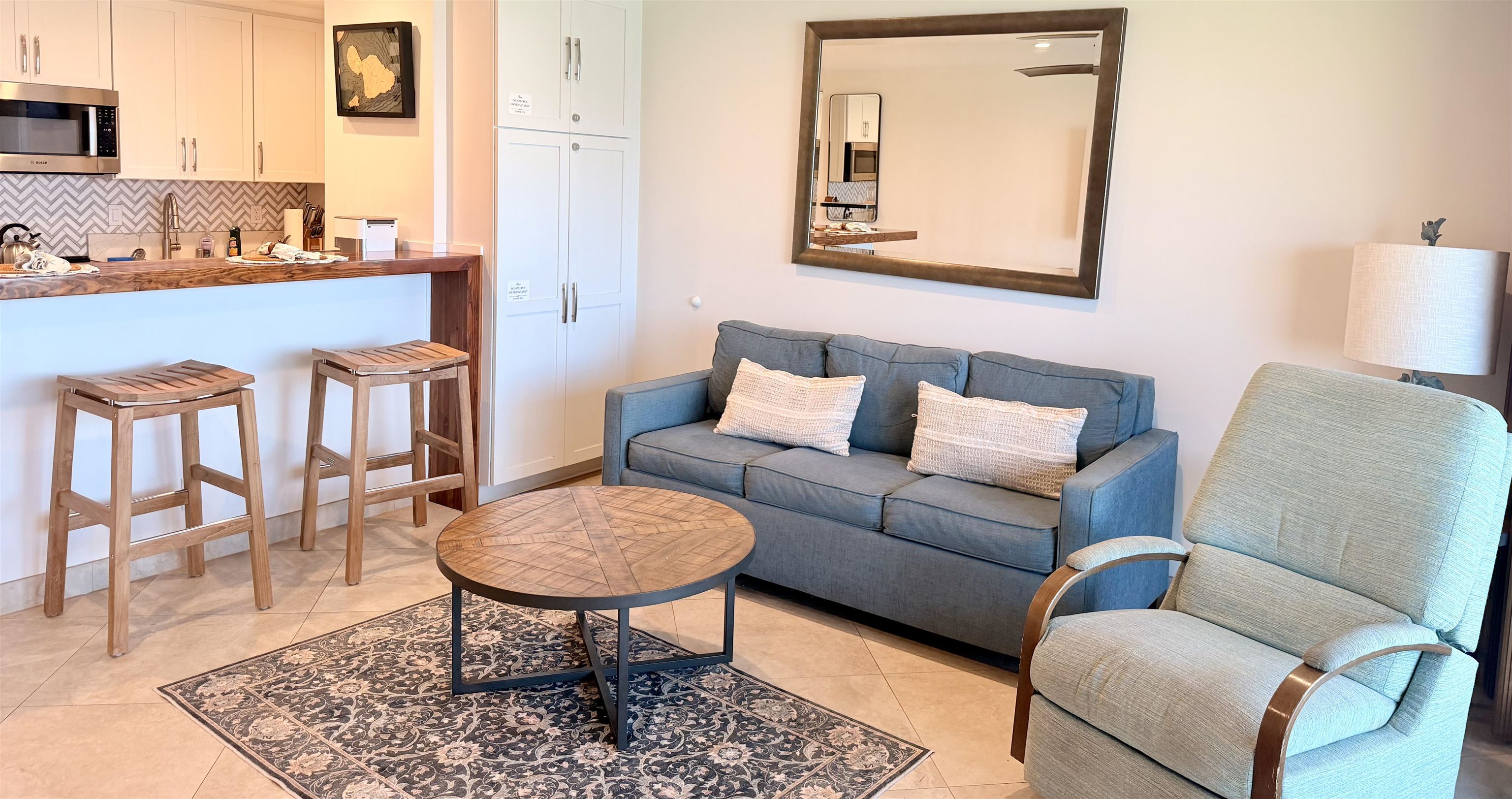 3701 Lower Honoapiilani Road, Unit 103 Lahaina, HI 96761 - Photo 8 of 38 a living room with furniture and a wooden floor