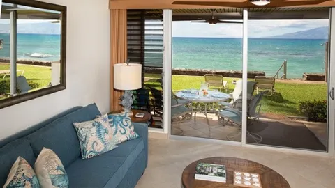 a living room with furniture a flat screen tv and a large window