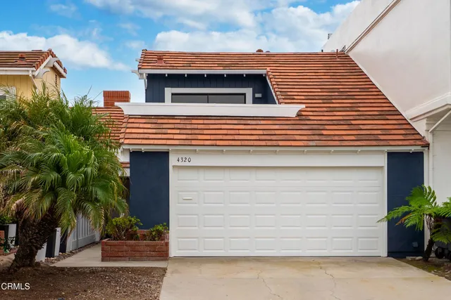 a side view of a house with a yard