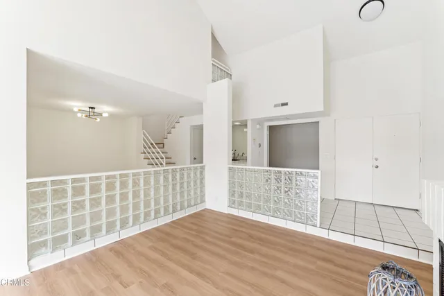 a view of an empty room with wooden floor