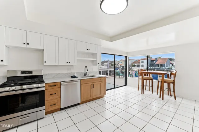 a kitchen with white cabinets and appliances