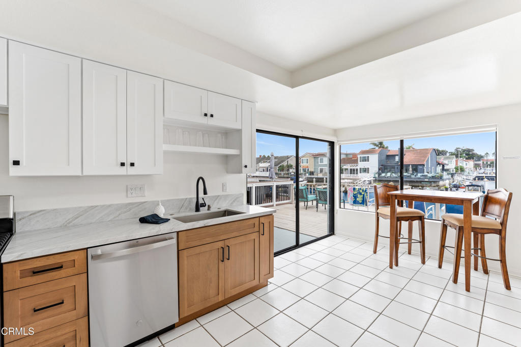 4320 Meridian Avenue Oxnard, CA 93035 - Photo 9 of 31 a kitchen with stainless steel appliances granite countertop a stove a sink and a refrigerator