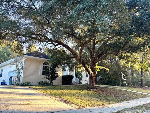 a view of a house with snow on the tree