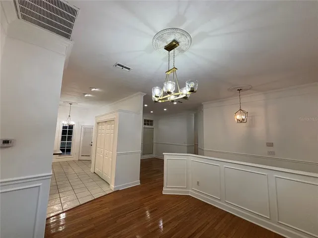 a view of a room with wooden floor and staircase