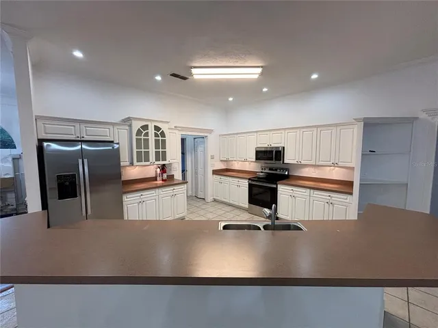 a view of a living room and kitchen